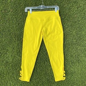 Bright yellow leggings with decorative ties by calf